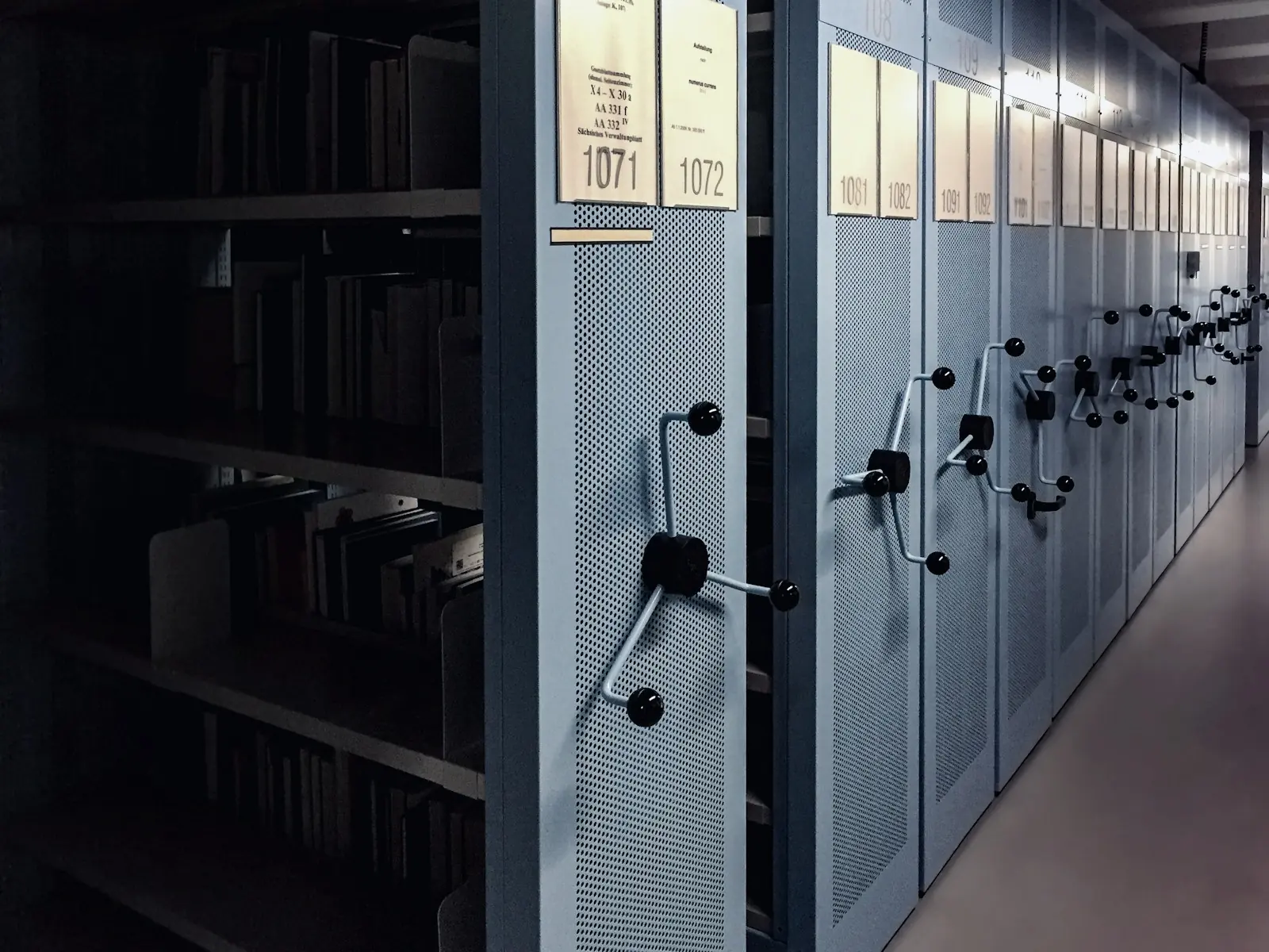 Rolling archive shelving packed with paper files